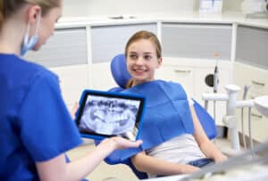 Doctor explaining are kids dental X-rays safe at dental clinic